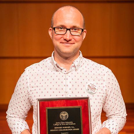 Erick Ramirez holding award plaque