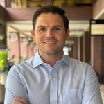 Kellen Moss, the President Bronco Builders Association, standing with his arms crossed for a professional photo