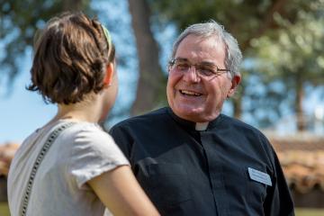A Jesuit talking with a student