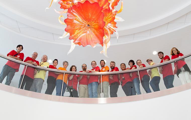 Group photo of AAH faculty and staff indoors, under a chandelier.