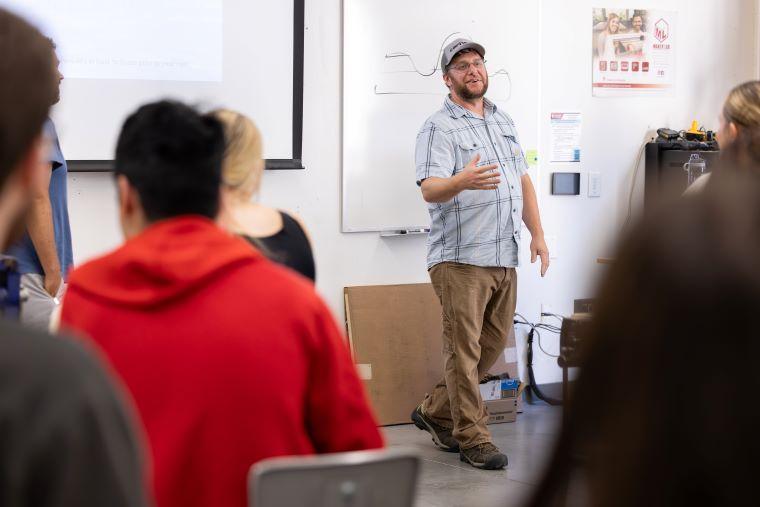 Ryan Carrington talking in front of students