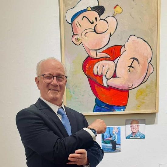 man standing in front of painting