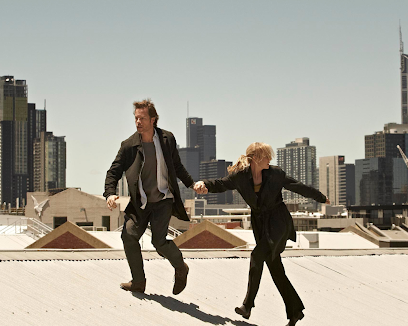 two people running over a rooftop