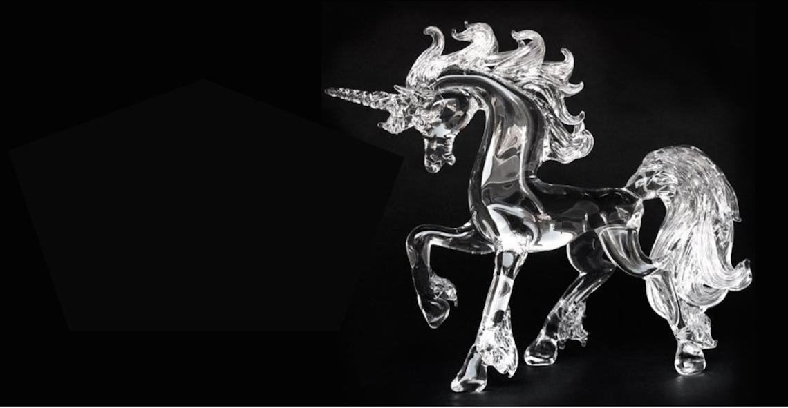 Glass unicorn sculpture on a black background from The Glass Menagerie.