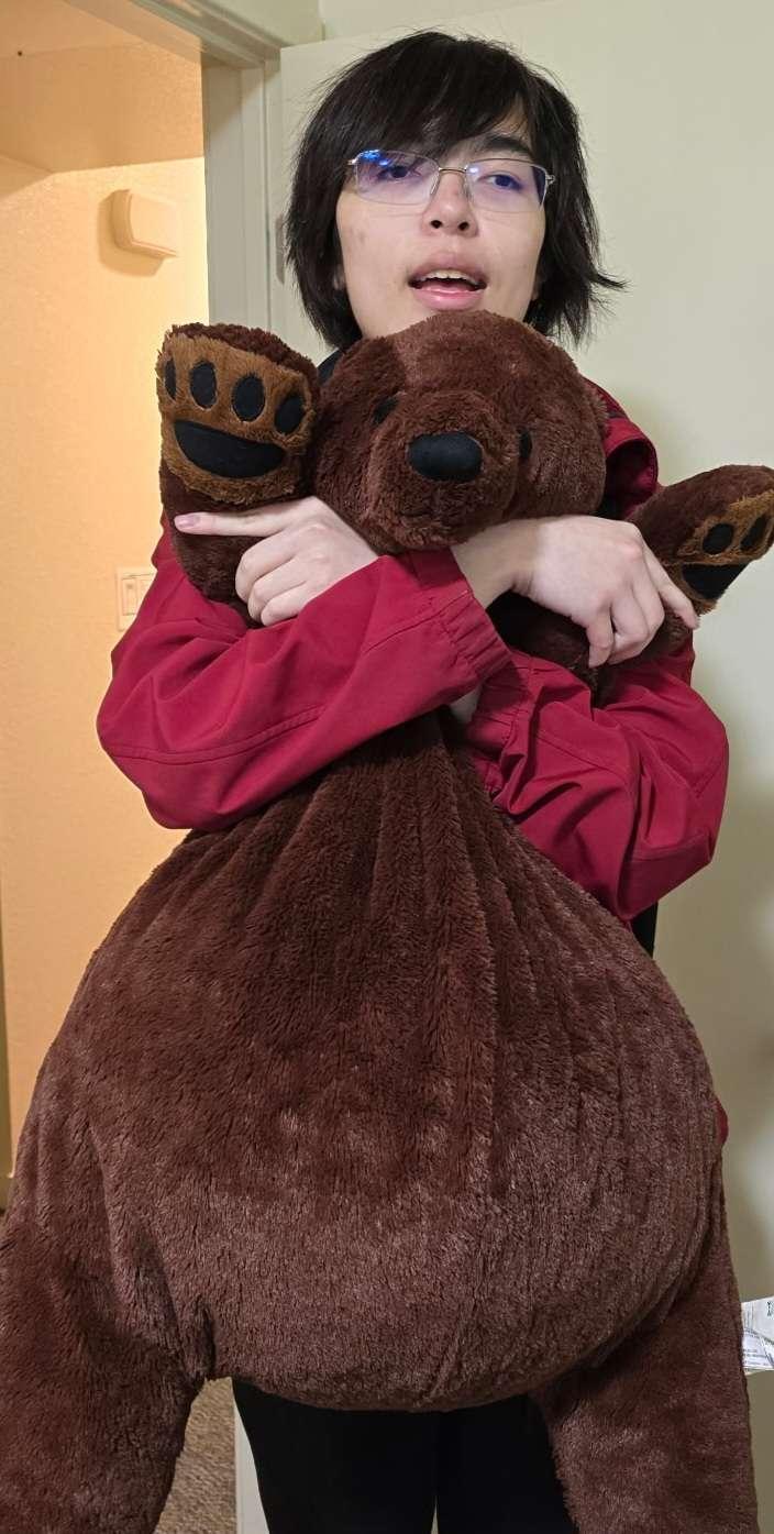 Cyrus Wong hugging a stuffed bear