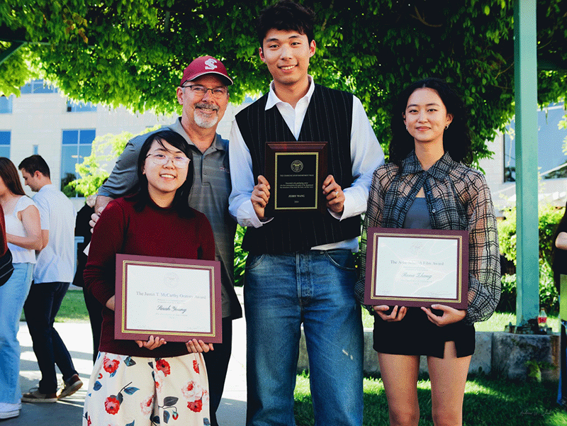 Justin T. McCarthy Award for Journalism recipient Sarah Young (left), Communication Department Chair Michael Whalen, Communication Department Prize recipient Jerry Wang, and Artie Schmidt Film Award recipient Rena Zhang (right).
