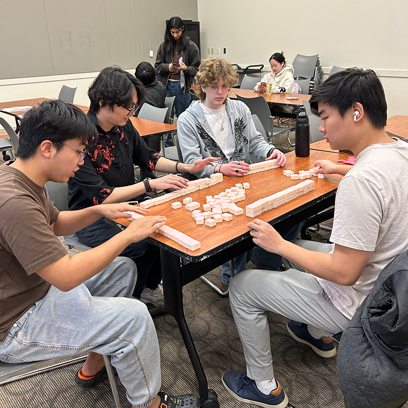 Students play Mahjong at Chinese New Year celebration.
