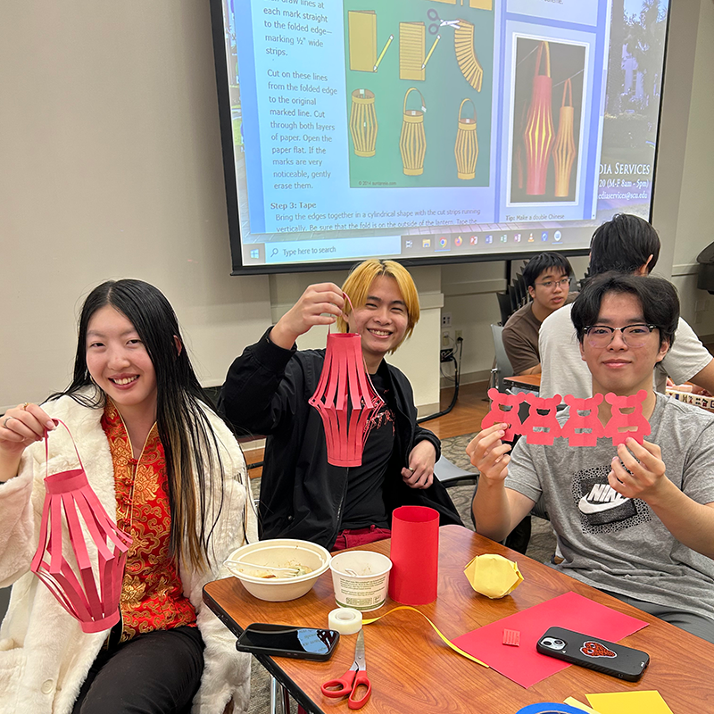 Students making paper lanterns at Chinese New Year celebration.