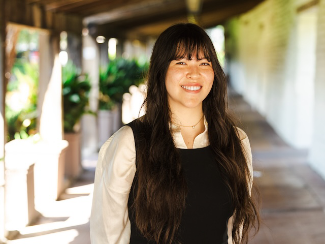 Ariana Yamasaki, 2025 Fulbright recipient, poses in the hallway near the Adobe Lodge.