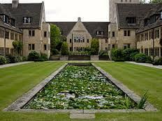 Nuffield College courtyard with manicured garden and symmetrical building façades.