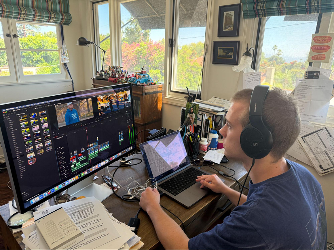 Henry Simonson sitting at his computer editing his project on the relience of the Central Altadena Little League