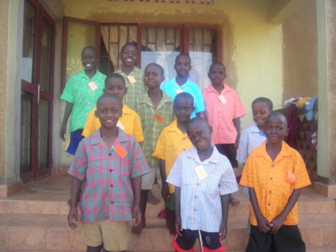 A group of people wearing colorful shirts standing outside a building.