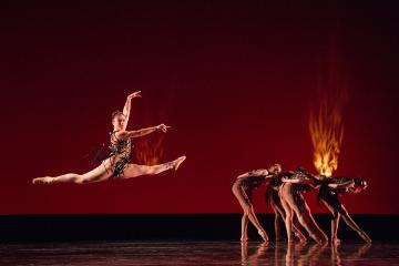 Female dancer in a split jump during an Images 2015 dress rehearsal