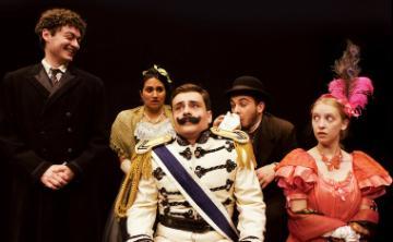 A theatrical performance of The Good Doctor with six actors in costumes.