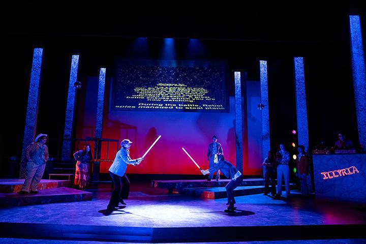 Scene from Shakespeares Twelfth Night set in a 1970s nightclub. 2 actors duel with lightsabers