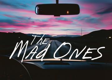 Sunset seen through a car windshield with text The Mad Ones in white
