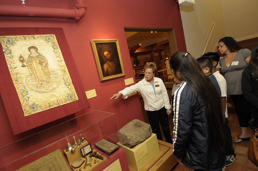 Image of docent giving a tour to school children.