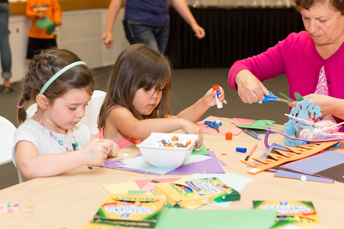 Two little girls making hands-on art.