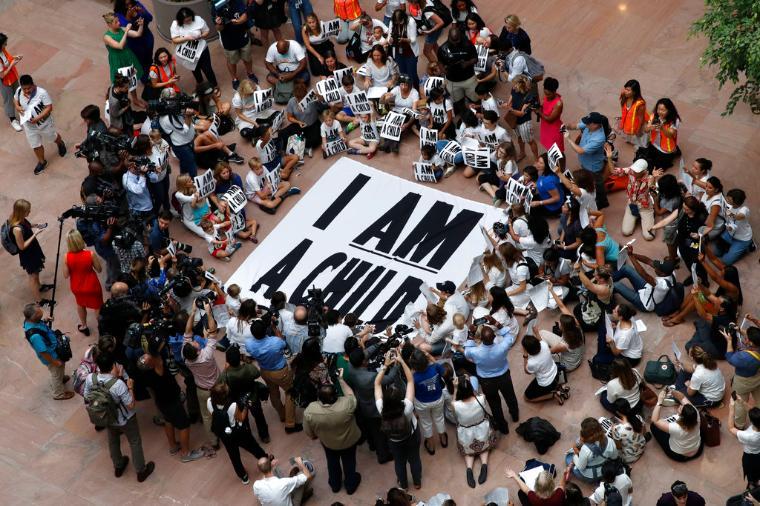 Families with young children protest the separation of immigrant families with a sit-in at the Hart Senate Office Building, Thursday, July 26, 2018, on Capitol Hill in Washington.  (AP Photo/Jacquelyn Martin)