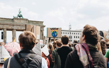 Protesters holding signs about climate change