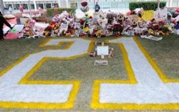 memorial in football field end zone with the number 21 painted on the field