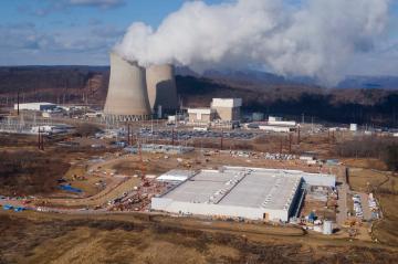 A data center owned by Amazon Web Services, front right, is under construction next to the Susquehanna nuclear power plant in Berwick, Pa., on Jan. 14, 2025. (AP Photo/Ted Shaffrey, file)