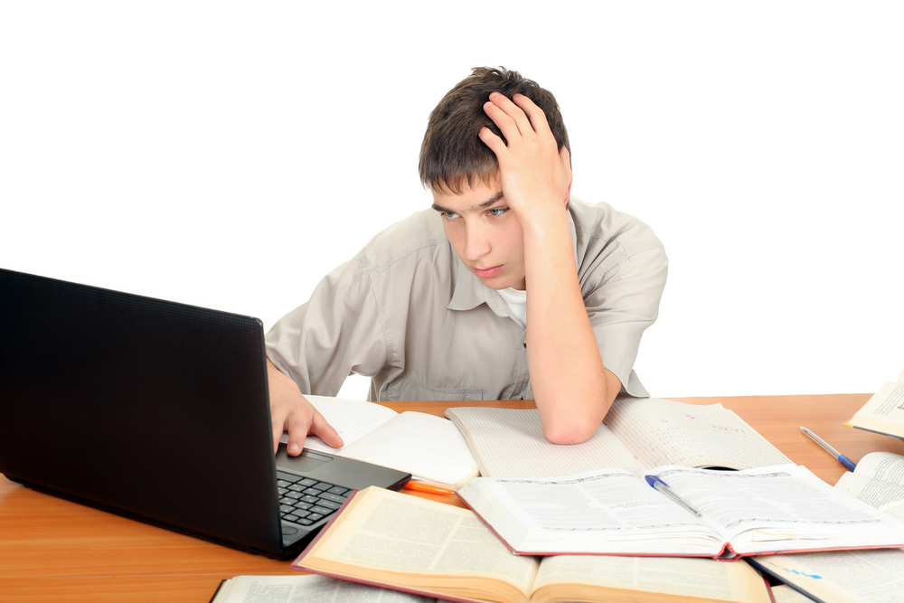 A boy working on homework at his desk