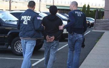 U.S. Immigration and Customs Enforcement agents taking a person into custody during operation Cross Check III in 2012. (AP Photo, U.S. Immigration and Customs Enforcement)
