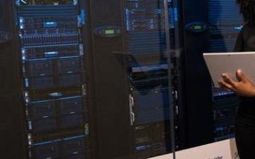 A person analyzing data on a chalkboard and laptop.