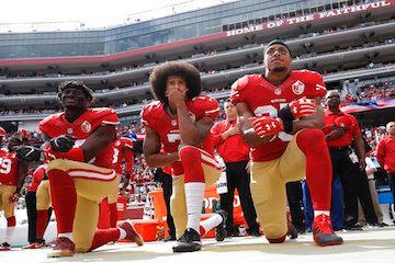 San Francisco 49ers outside linebacker Eli Harold, left, quarterback Colin Kaepernick, center, and safety Eric Reid kneel during the national anthem before the team's NFL football game against the Dallas Cowboys in Santa Clara, Calif. Kaepernick accepted Sports Illustrated's Muhammad Ali Legacy Award from Beyonce on Tuesday night, Dec. 5, 2017, and promised that with or without the NFL's platform