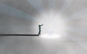 Man in suit with big bright lightbulb. Image by saifas5417 via Pixabay.