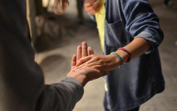 Man and woman holding hands on street