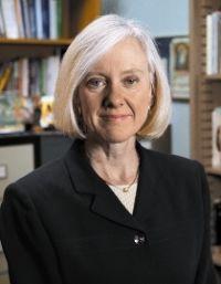 A person standing in an office, titled 'Cahill Headshot'. image link to story
