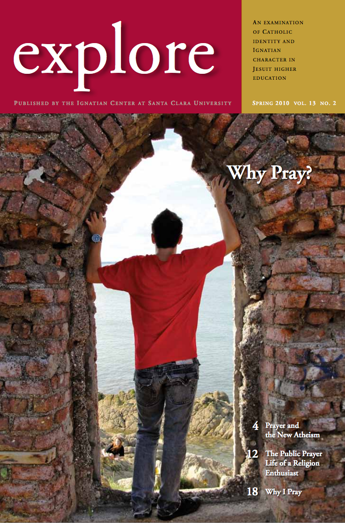 A person standing in a stone archway with explore text on the top.