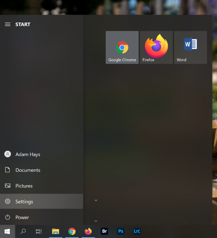 An image of the Windows Start menu with a red arrow pointing to Settings.