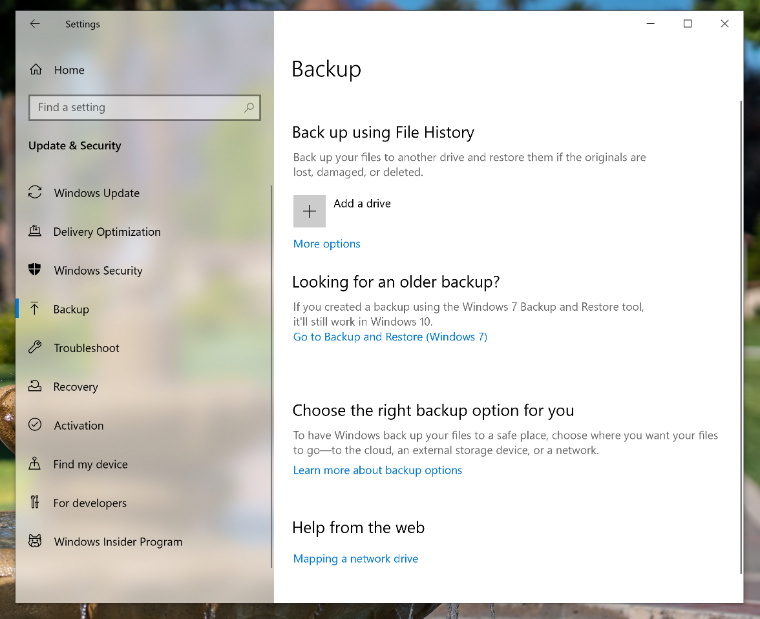 An image of the Windows 10 Backup page with a red arrow pointing to Add a drive.
