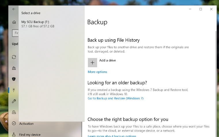 An image of the Windows 10 Backup page showing the select a drive menu with a red arrow pointing to the external drive My SCU Backup (F:).