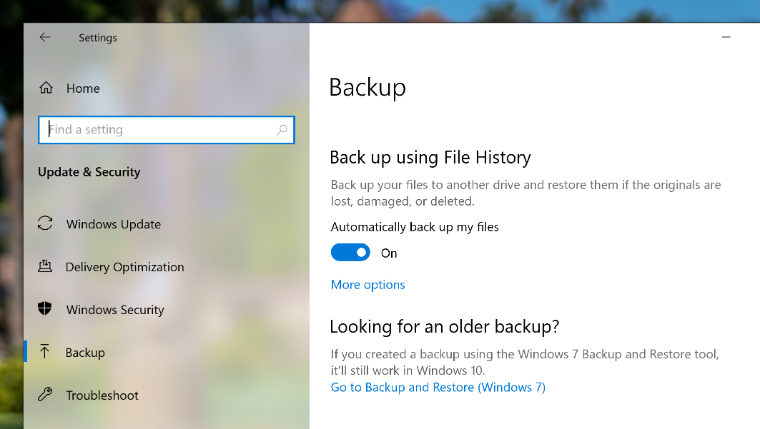 An image of the Windows 10 Backup page showing a red arrow pointing to More options.