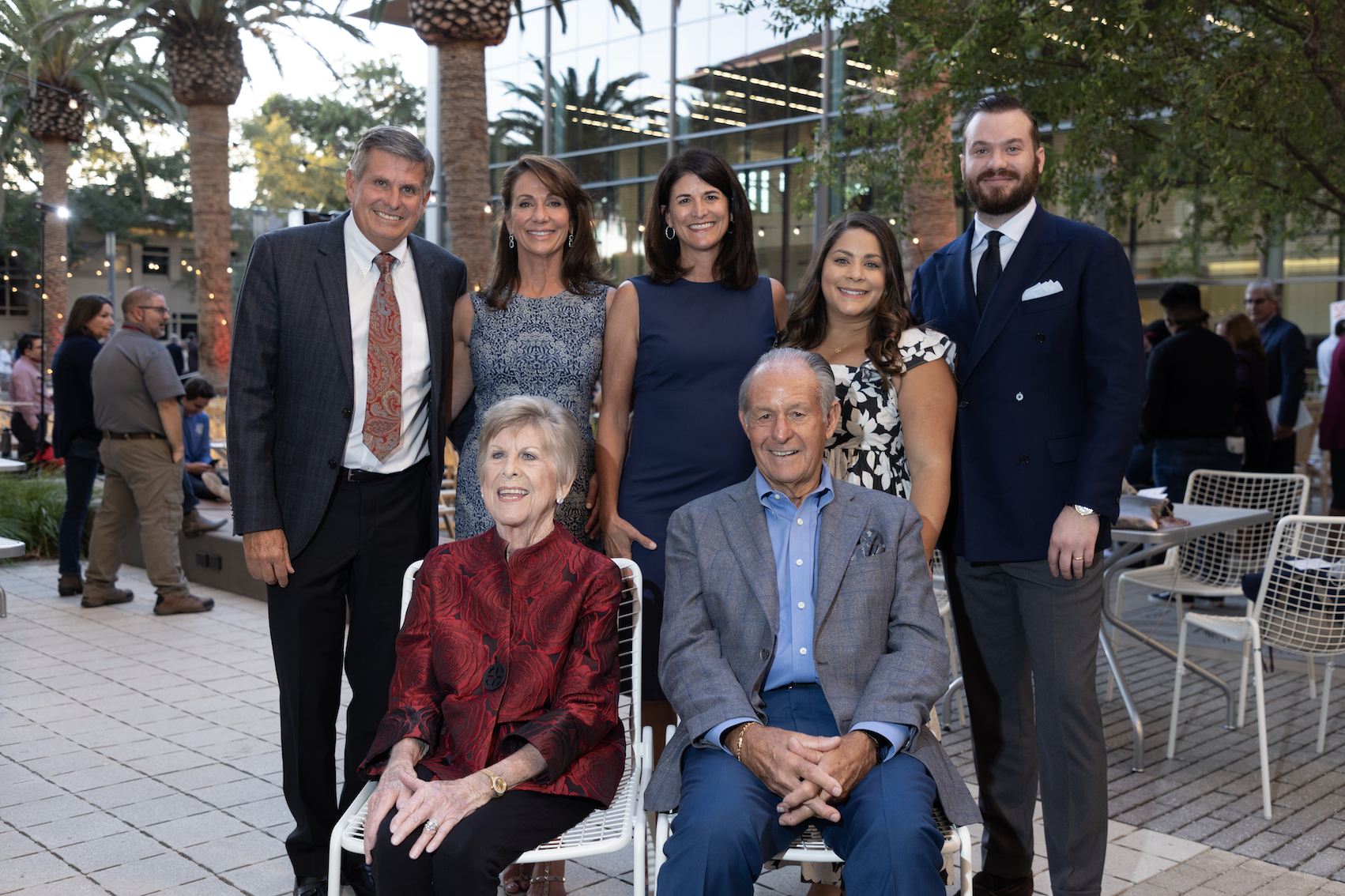 A group photo of seven people outdoors.