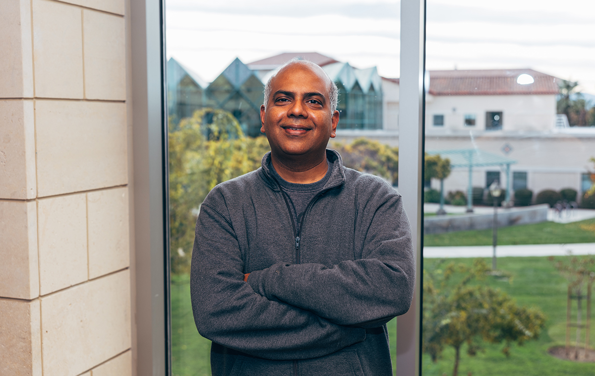 Ram Bala stands in front of window in Lucas Hall