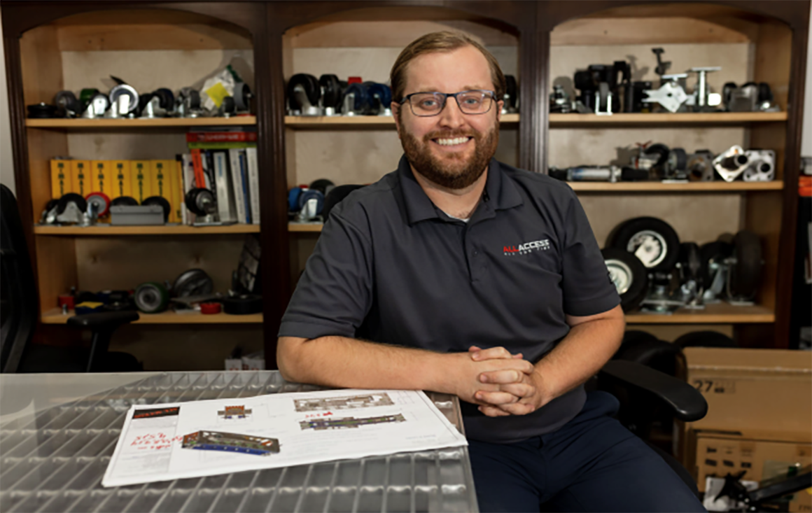Alum Joey Brennan sits at desk