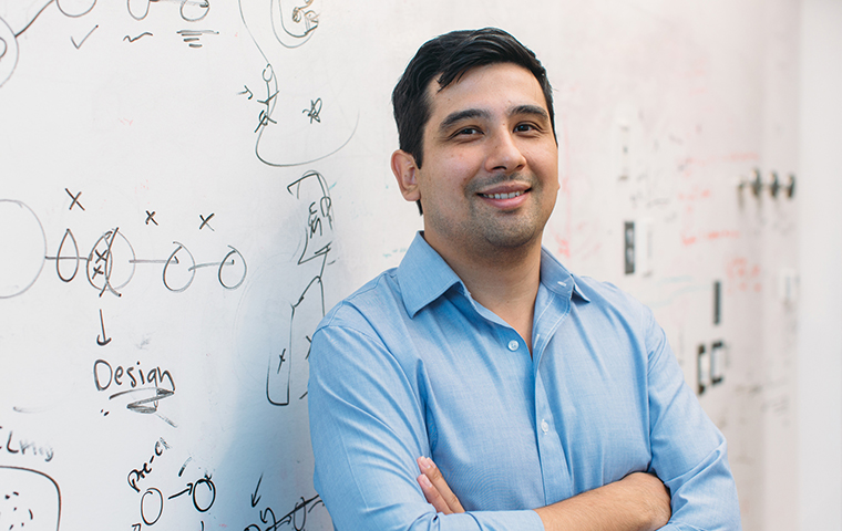 Photo of 2009 alumnus Jason Buenrostro in front of a whiteboard image link to story