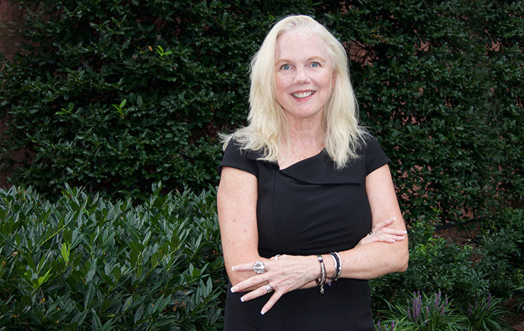 Brigit Helms, new ED of Miller Center, torso photo against dark background