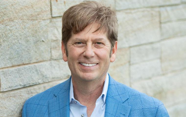 Lawrence Lokman standing in front of brick wall