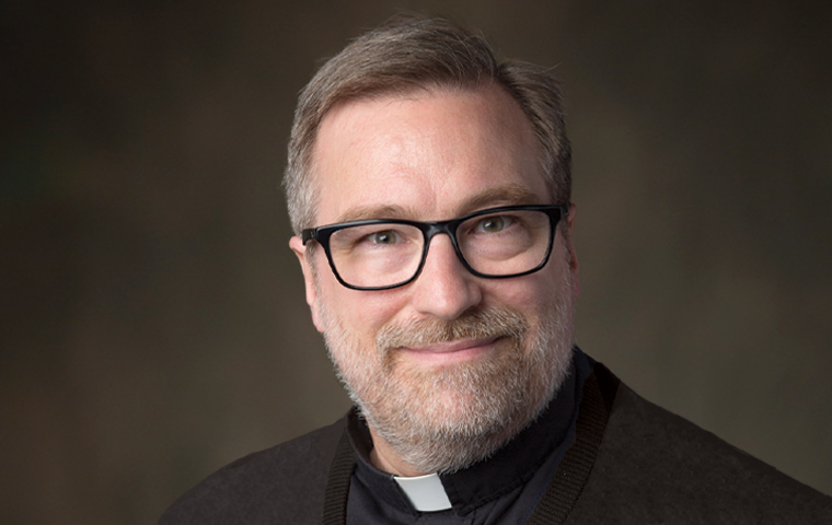 Headshot of Fr. Joseph Mueller, S.J., in collar