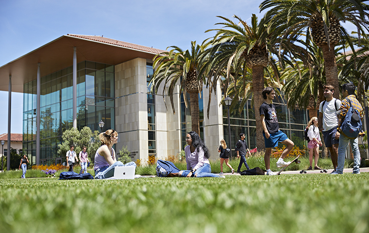Students seated on lawn in front of Sobrato Campus building image link to story