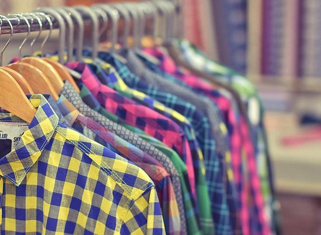 Photo of a rack of colorful mens plaid shirts.