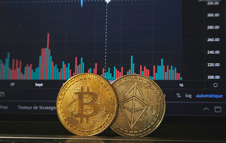 Image of 2 bitcoins in front of a bar chart