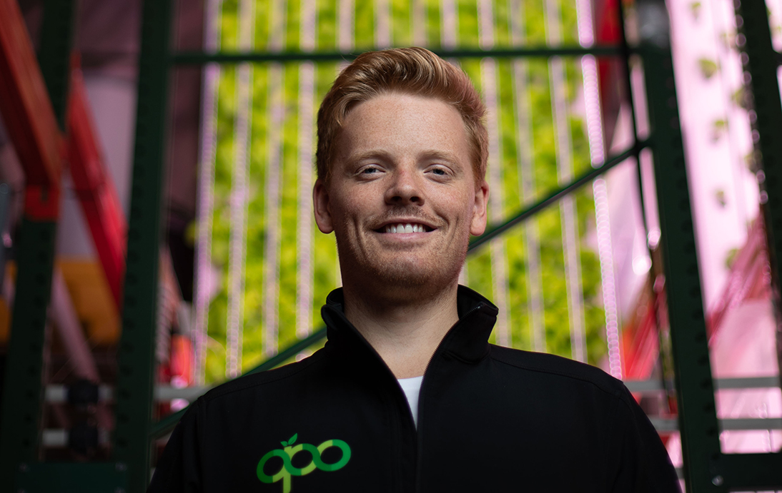 Sam Bertram stands in front of his robotic farming equipment