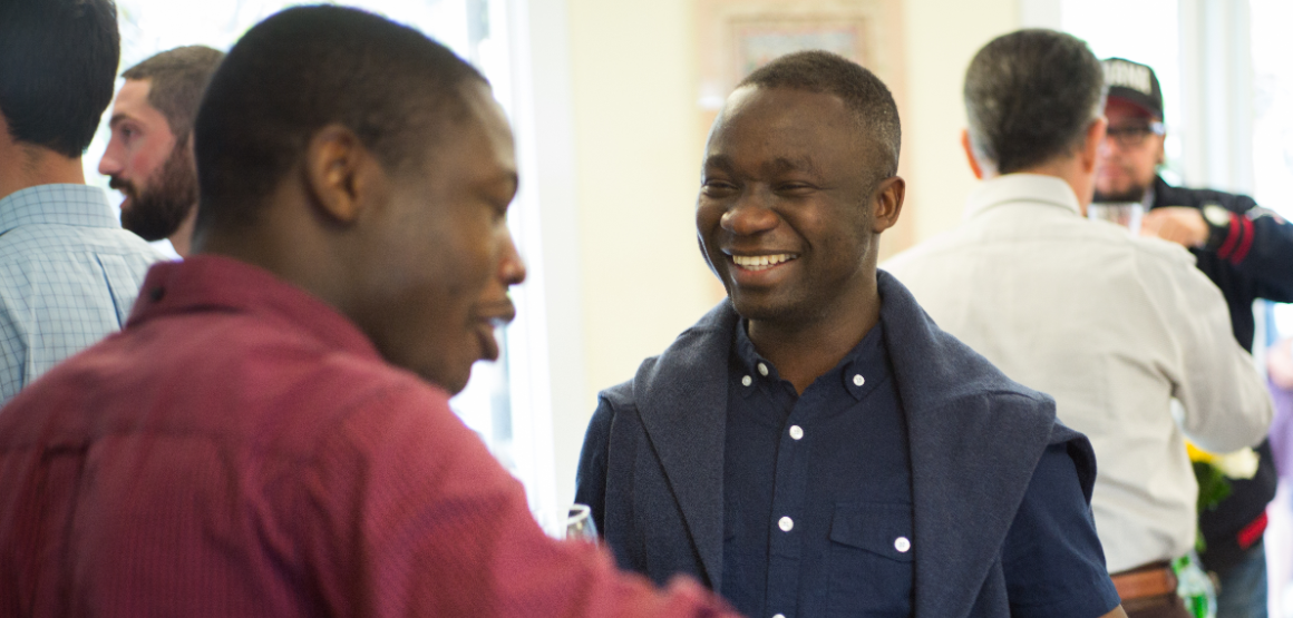 An international student talks energetically with another